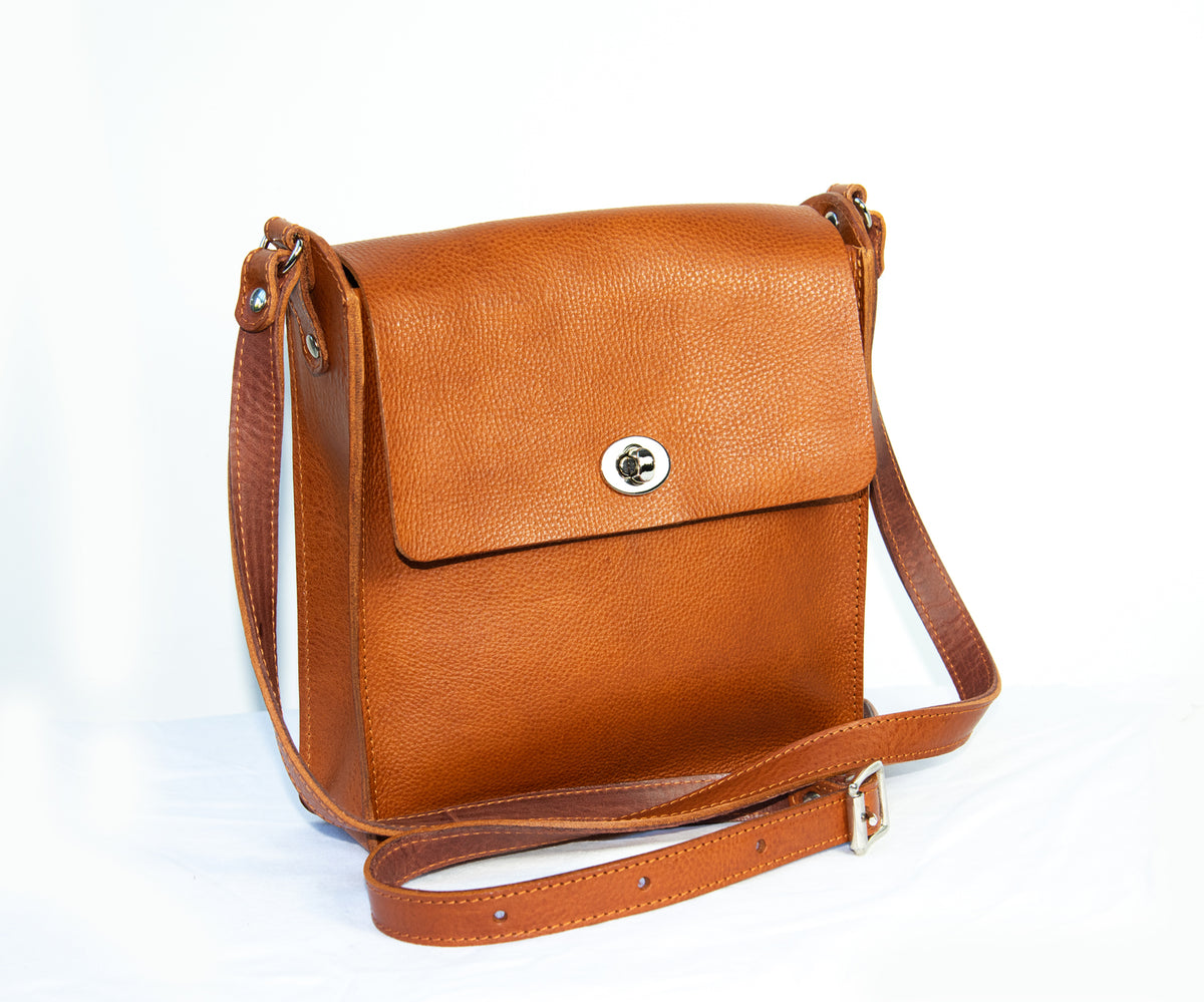 Flora Box crossbody bag in tan veg tanned leather