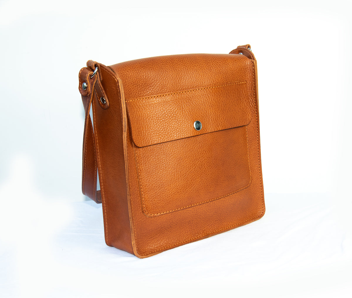 Flora Box crossbody bag in tan veg tanned leather
